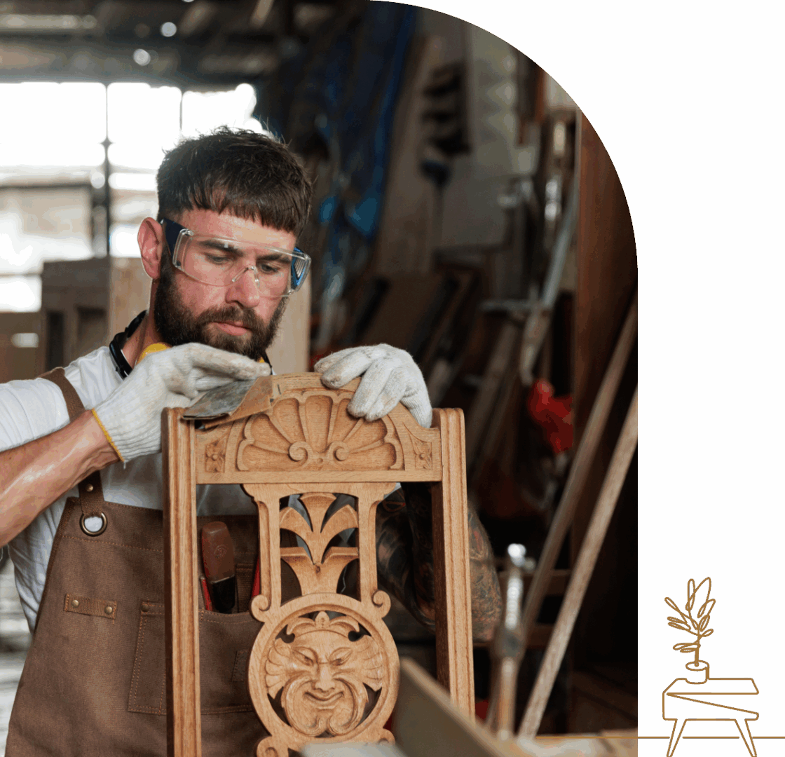 Craftsman carving intricate wooden chair design.