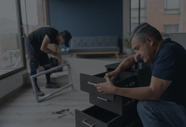 Men assembling furniture in a modern room.